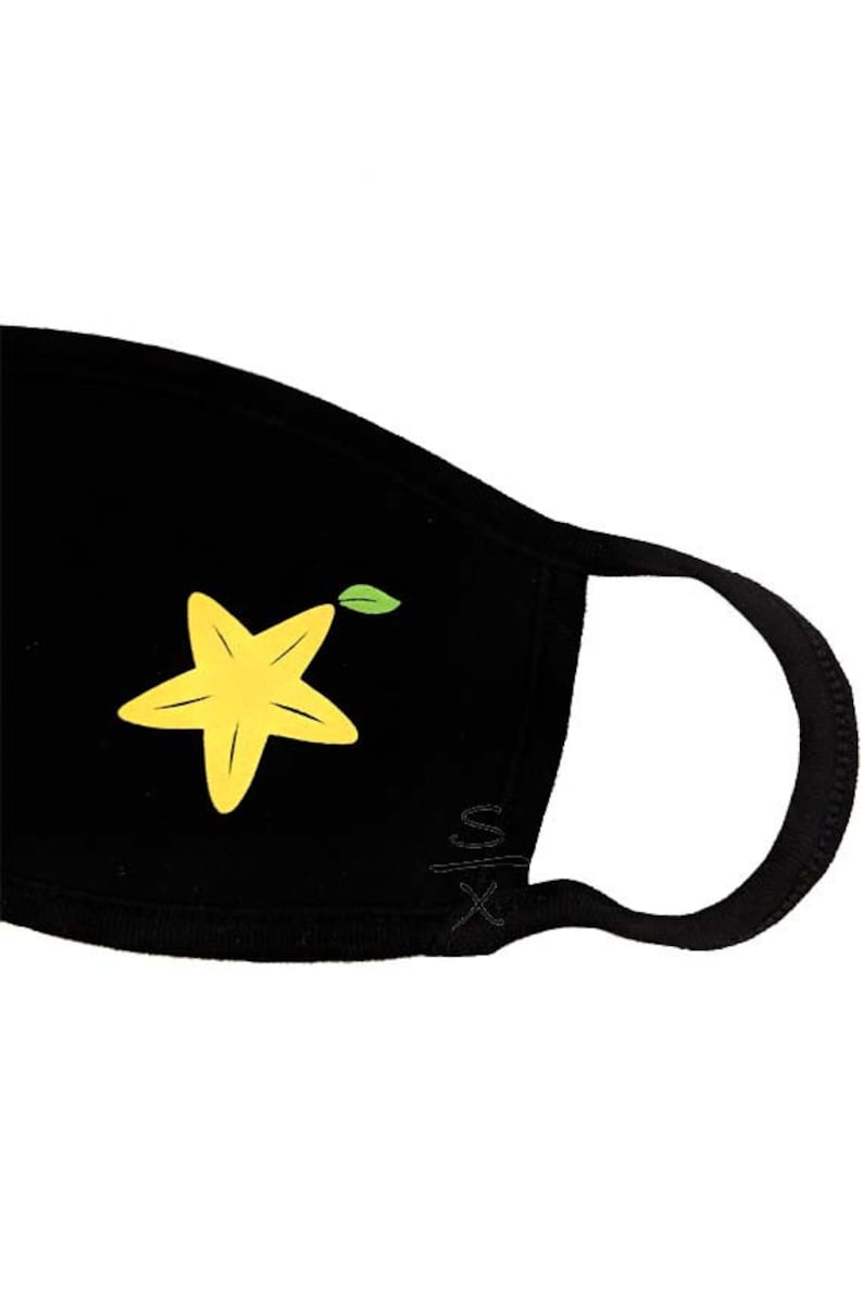 May include: Black face mask with a yellow starfruit design. The starfruit has a green leaf.