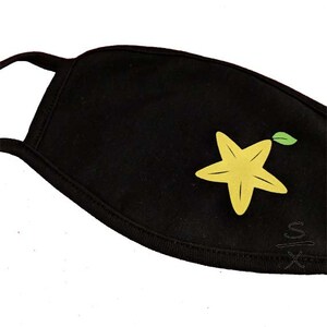 May include: Black face mask with a yellow starfruit design. The starfruit has a green leaf.