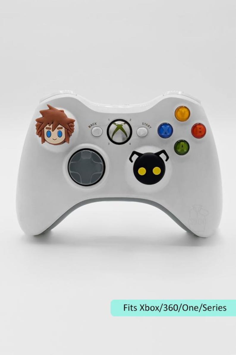 May include: White Xbox controller with character art. The controller has a gray directional pad and buttons in various colors. The text "Fits Xbox/360/One/Series" is at the bottom.