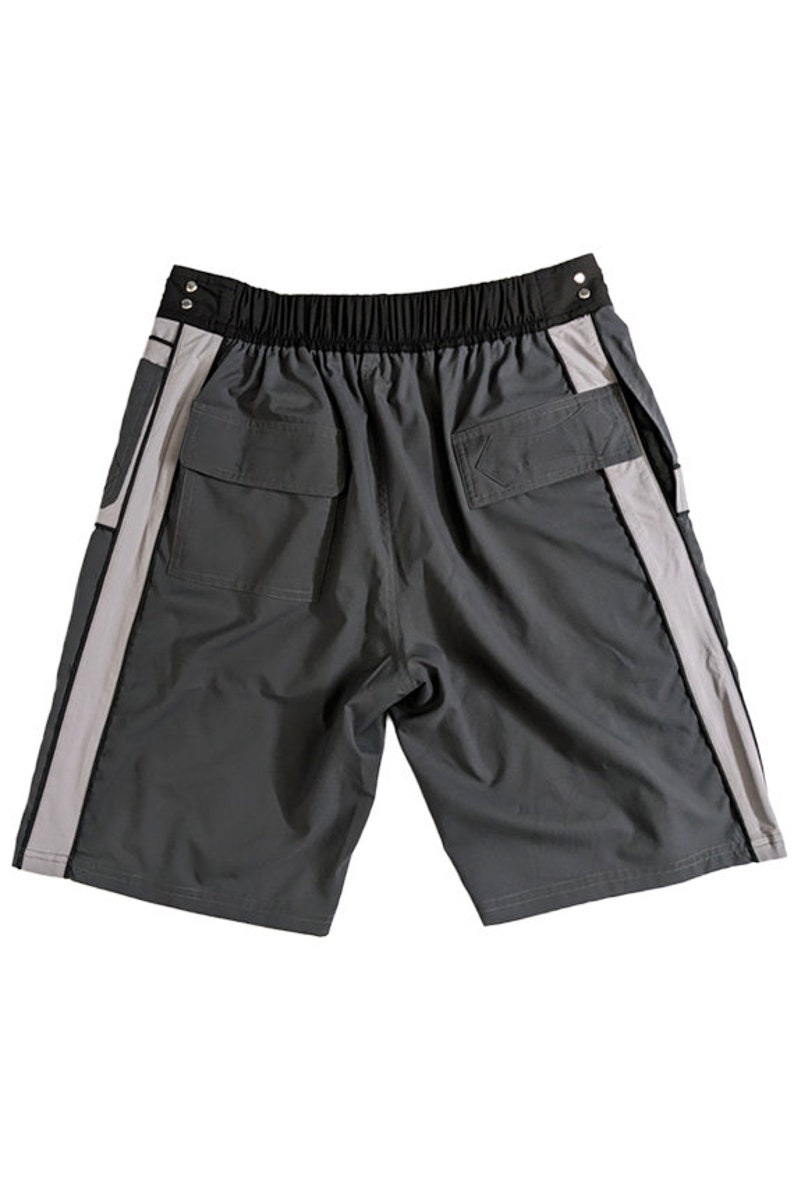 May include: Gray shorts with black waistband and white side stripes. The shorts have two back pockets.