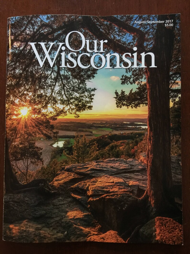 May include: A magazine cover with a sunset scene featuring a large tree with a thick trunk and branches. The magazine is titled "Our Wisconsin" with the August/September 2017 issue date and a price of $5.00.