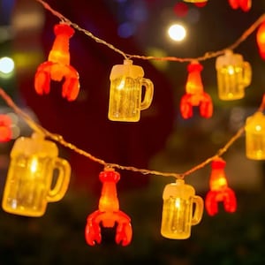 May include: String of fairy lights with alternating beer mug and lobster designs. The lights are warm white and the designs are clear plastic.