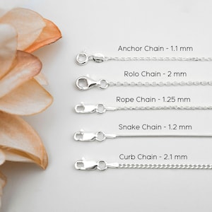 May include: Five silver chains with lobster claw clasps, labeled as follows: Anchor Chain 1.1 mm, Rolo Chain 2 mm, Rope Chain 1.25 mm, Snake Chain 1.2 mm, and Curb Chain 2.1 mm. Each chain is displayed horizontally with its specific name and width.