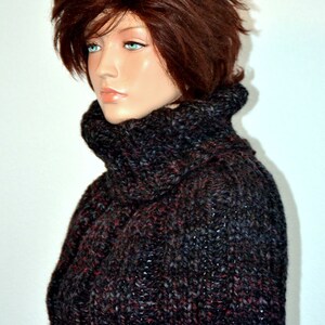 May include: A black and burgundy knitted cowl neck sweater with a textured pattern.
