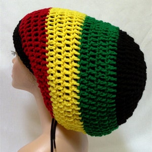 May include: A crocheted beanie hat in red, yellow, green, and black colors. The hat is made with a loose knit stitch and has a long, flowing style.