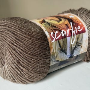 Scarfie Yarn by Lionbrand.  Cream/ Taupe. 312 yd/ 285 m