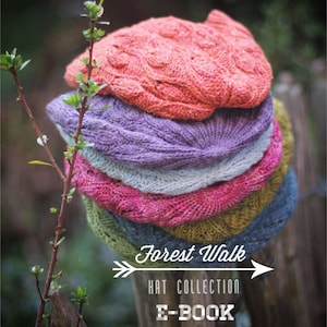 May include: A stack of five knitted hats in various colors, including orange, purple, blue, pink, and green. The hats are arranged in a pile, with the orange hat on top. The hats are all made with a similar stitch pattern, and they have a slightly textured look. The hats are sitting on a wooden fence post, and there is a green plant in the background. The text "Forest Walk Hat Collection E-Book" is written on the image.