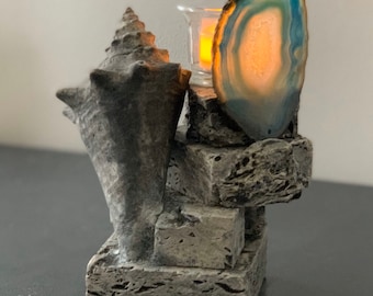 Vela votiva de té de concha de piedra y fósil