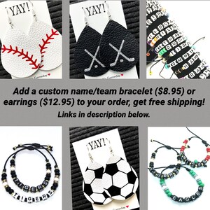 May include: A set of three different custom name/team bracelets and earrings. The bracelets are black and white with the words "TIGERS", "EAGLES", and "CHIEFS" spelled out in black beads. The earrings are leather and feature a baseball, hockey sticks, and a soccer ball design. The text "YAY!" is on each of the earring cards.