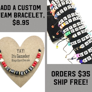 May include: A red, white, and black beaded bracelet with the word "CHIEFS" spelled out in black letter beads. The bracelet is displayed on a heart-shaped piece of cardboard with the text "YAY! It's Gameday BlingirlSpirit.Etsy.com".