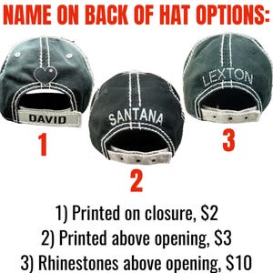May include: Three black baseball caps with white contrast stitching shown from the back. Option 1 features a heart icon and the name DAVID on the closure. Option 2 displays the name SANTANA above the opening. Option 3 shows the name LEXTON in rhinestones.
