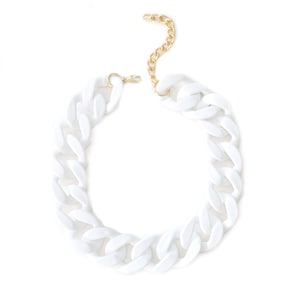 May include: A white chunky chain necklace with a gold clasp.