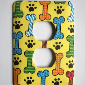 Dog Bones and Paw Prints on Yellow Background Outlet Cover image 1