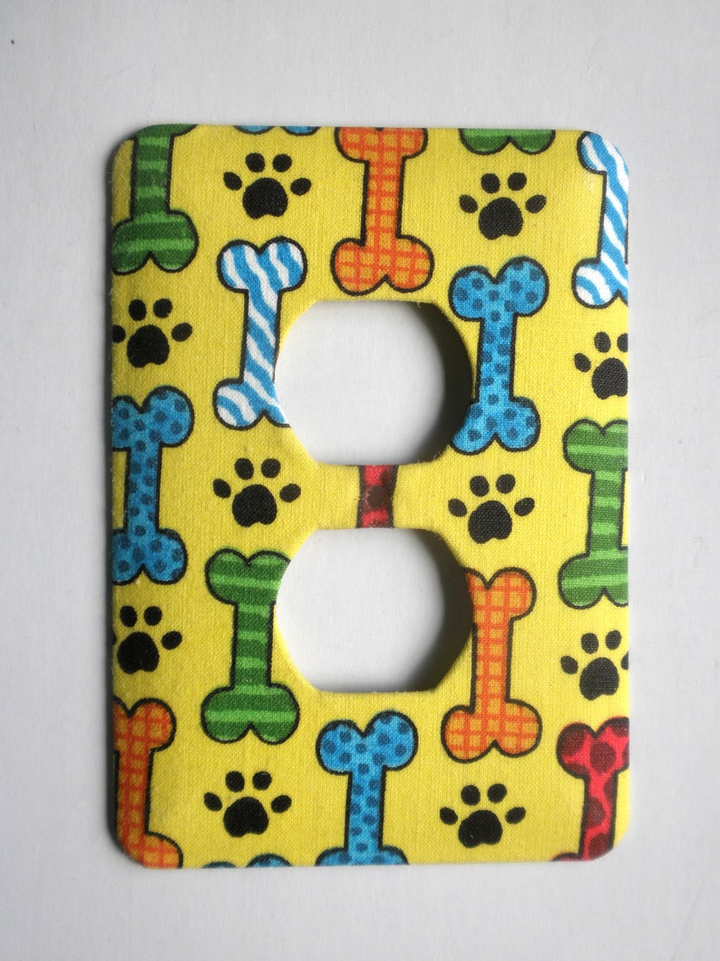 Dog Bones and Paw Prints on Yellow Background Outlet Cover image 1