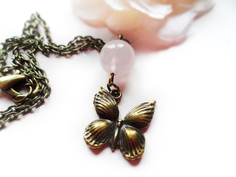 Selma Dreams Beautiful brass necklace with a romantic butterfly pendant and rose quartz pearl