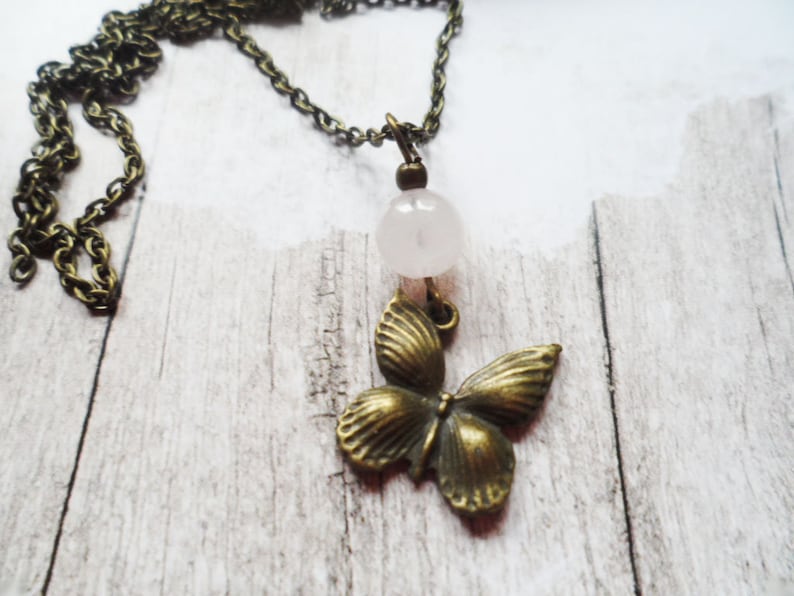 Selma Dreams Beautiful brass necklace with a romantic butterfly pendant and rose quartz pearl