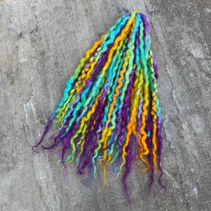 May include: A set of three ceramic mugs with a speckled, matte finish. The mugs are in shades of cream, light grey, and dark grey. Each mug has a simple, minimalist design, ideal for coffee or tea.