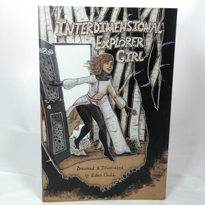 May include: A book cover with a black background and a white birch forest. The title is "Interdimensional Explorer Girl" with the text "Dreamed & Illustrated by Eden Chubb" at the bottom. A girl in a white coat and black trousers is stepping through a door.