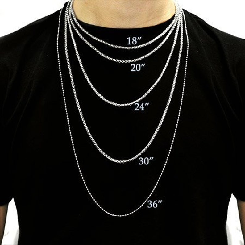 May include: A silver chain necklace is shown on a model wearing a black shirt. The chain is shown in five different lengths: 18 inches, 20 inches, 24 inches, 30 inches, and 36 inches.
