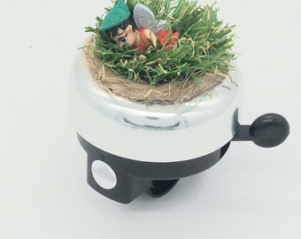 Bicycle bell with elf on artificial grass