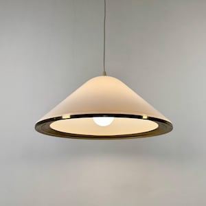 May include: A white conical pendant light fixture with a gold-colored trim and a light bulb. The light hangs from a thin wire against a plain white background. The fixture has a mid-century modern design.