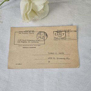May include: Vintage official business postcard with text including "Early for Christmas" and a Los Angeles County stamp dated December 2, 1944. The postcard is addressed to Thomas J. Smith.