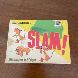 May include: A vintage board game box with a yellow background and the words "Waddington's Slam!" in red. The box features illustrations of cartoon mice and the text "A hilarious game for 2-7 players".