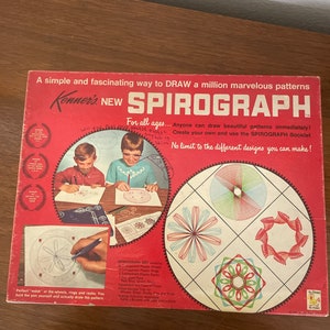 May include: A red and white box with the words "Kenner's New Spirograph" on the front. The box shows two children drawing with the Spirograph, and a variety of colorful geometric patterns. The text on the box says "For all ages... Anyone can draw beautiful patterns immediately! Create your own and use the SPIROGRAPH Booklet. No limit to the different designs you can make!"
