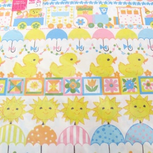May include: A yellow and white wrapping paper with a repeating pattern of ducks, umbrellas, suns, and flowers. The paper also features a train with a yellow, blue, and red color scheme.