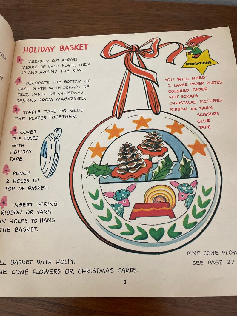 Peut inclure: Un projet d'artisanat pour r&eacute;aliser un panier de No&euml;l. Les instructions comprennent la d&eacute;coupe de deux assiettes en papier, leur d&eacute;coration avec du feutre, du papier ou des motifs de No&euml;l, et leur agrafage ensemble. Le panier est ensuite d&eacute;cor&eacute; d'un ruban rouge et d'une petite figurine d'elfe.