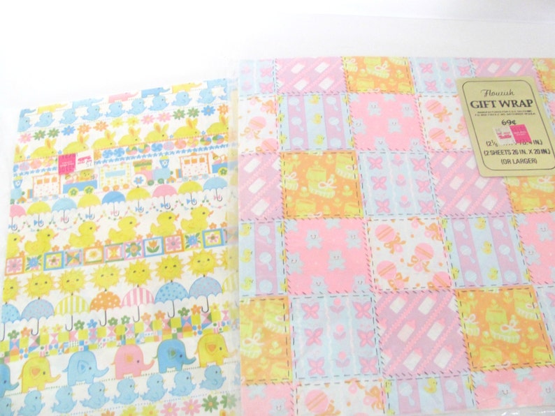 May include: Two sheets of pastel-colored gift wrap with a patchwork design featuring baby animals, flowers, and umbrellas. The text on the label reads "Flourish Gift Wrap 694 2 Sheets 25 in. x 20 in. (63.5 cm x 50.8 cm) For Larger Gifts."
