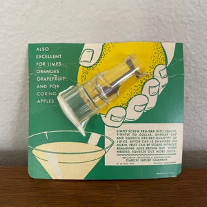 May include: A green and white cardboard package with a clear plastic citrus juicer. The juicer is shown being used on a lemon. The package includes instructions for using the juicer and lists the fruits it can be used on: limes, oranges, grapefruit, and apples.