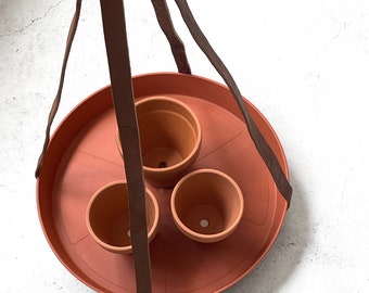 Plant bowl, minimalist plant holder made from sustainable vegetable tanned leather, cognac coloured leather with terracotta plastic plate