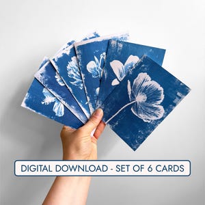 May include: A set of six blue and white floral cards. The cards feature botanical prints of flowers in white against a deep blue background. The text "DIGITAL DOWNLOAD - SET OF 6 CARDS" is displayed on the image.