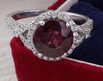 Garnet with Diamond Halo and side Diamonds in 18 karat white gold