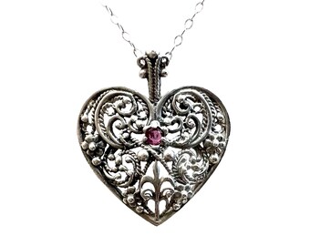 Cut-out heart pendant with scroll work and center ruby in sterling silver