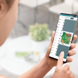 May include: A person is using a smartphone to view a map with different coloured regions. The map is displayed on the screen of the phone. The phone is black with a curved screen.