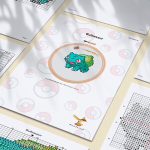 May include: Cross stitch pattern for a Bulbasaur Pokemon character. The pattern includes a color chart, a grid with black dots, and a finished design in a hoop. The finished design is green, red, and white.