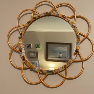 Orange wood mirror with sea glass and seashells.