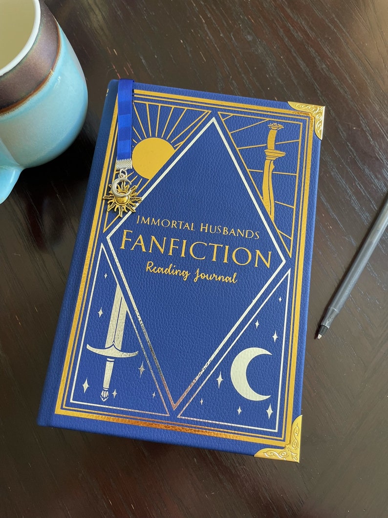 May include: A blue reading journal with gold accents and the title "Immortal Husbands Fanfiction Reading Journal".