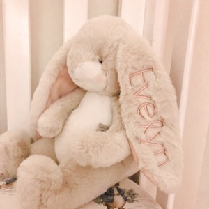 Monogrammed stuffed bunny with name on the ear. Cream bunny shown with pink monogram