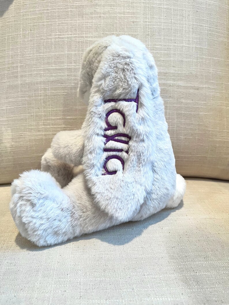 Monogrammed stuffed bunny with name on the ear. Grey bunny shown with purple monogram