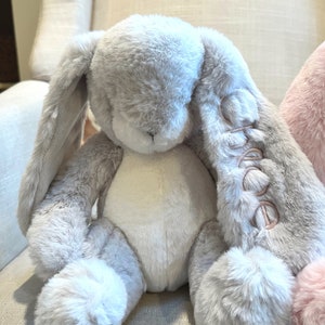 Monogrammed stuffed bunny with name on the ear. Grey bunny shown with pink monogram