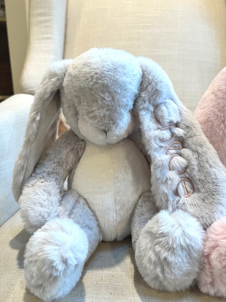 Monogrammed stuffed bunny with name on the ear. Grey bunny shown with pink monogram