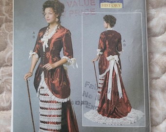May include: A sewing pattern for a red and white dress with a long train. The pattern is for sizes 14-16-18-20-22 and is from Butterick. The pattern number is B6572.