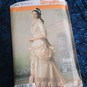May include: A Simplicity sewing pattern for a Victorian-style wedding dress. The pattern is for sizes 6, 8, 10, and 12. The pattern is from the Victorian Bridal Museum.
