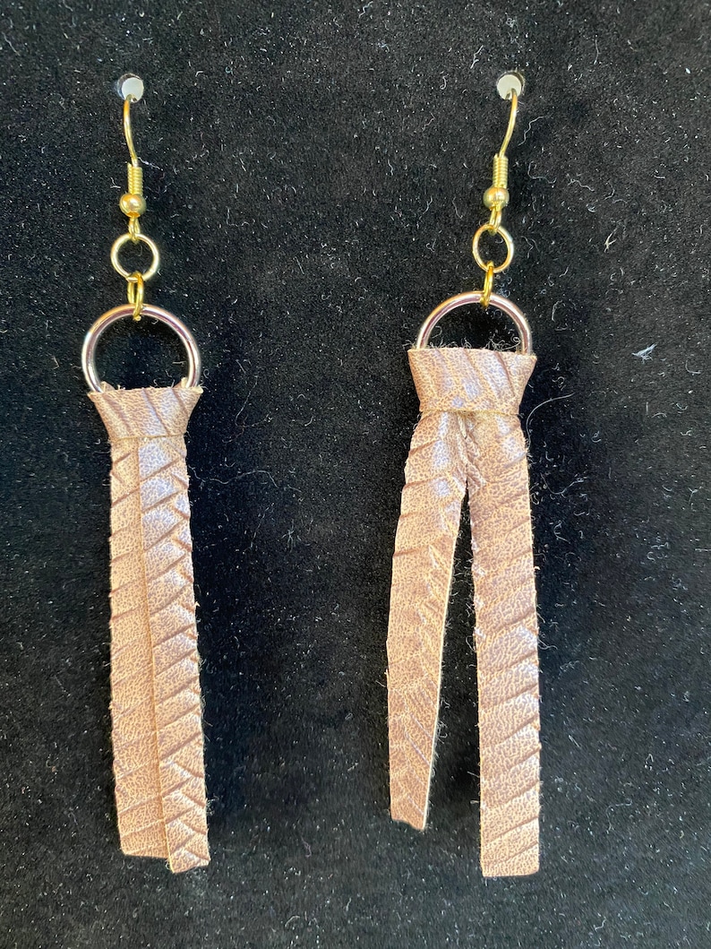 Tan faux leather earrings.