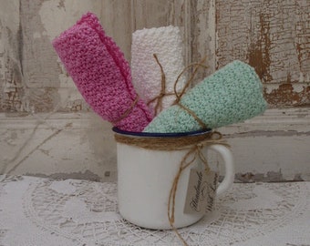 3 guest towels, crocheted, in an enamel cup