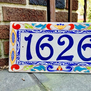 Colorful number home plaque with delft border followed by a colorful italian design