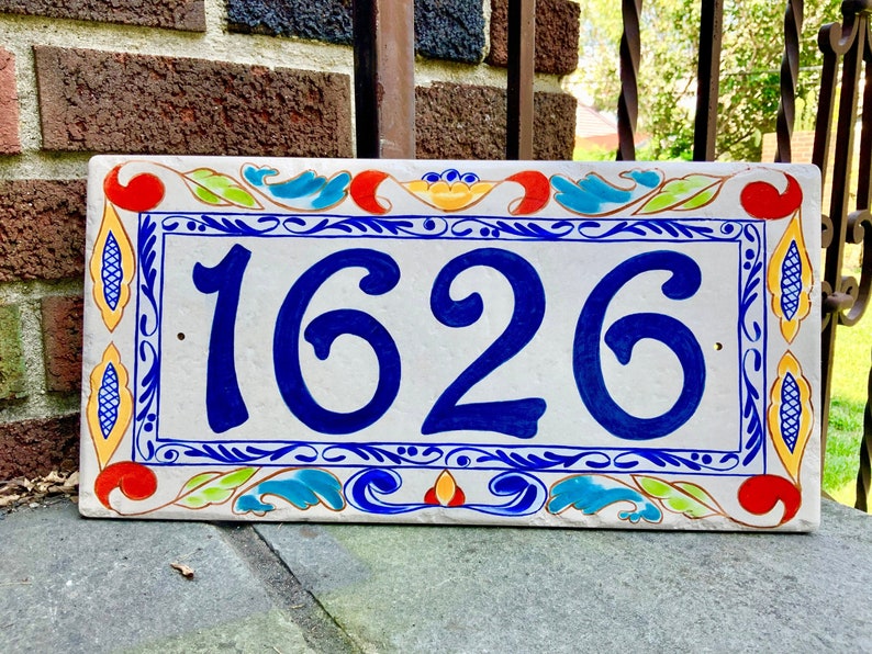 Colorful number home plaque with delft border followed by a colorful italian design